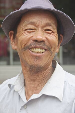NANJING ROAD, SHANGHAI - AUGUST 20:  Unidentified Chinese man smiles at camera on August 20, 2009 along Nanjing Road in Shanghai, China.  Nanjing Road is a tourist Haven in China.  のeditorial素材