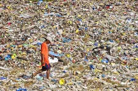 CAVITE, PHILIPPINESS. - FEBRUARY 12: Unidentified scavengers rummage for recyclable items on...