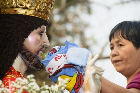 A devotee wipes the face of the statue of the Black Nazarene.  Millions of people attended the...