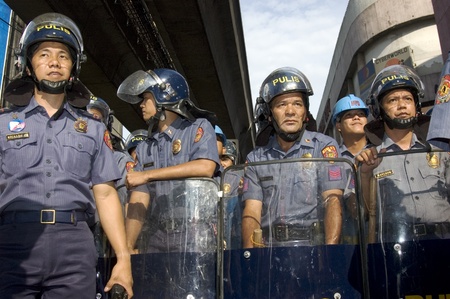 MANILA - MAY 1: Riot policemen get ready to protect Malacanang Palace in the Philippines from...