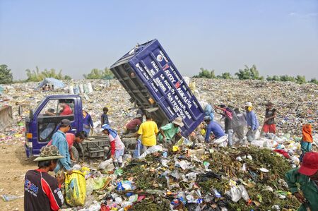 CAVITE, PHILIPPINESS. - FEBRUARY 12: Unidentified scavengers rummage for recyclable items on...