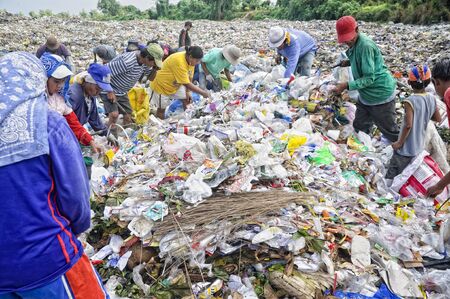 CAVITE, PHILIPPINESS. - FEBRUARY 12: Unidentified scavengers rummage for recyclable items on...
