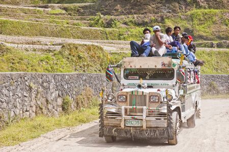 BANAUE, PHILIPPINES - APRIL 3: Unidentified men riding dangerously atop an assembled-from-junk...