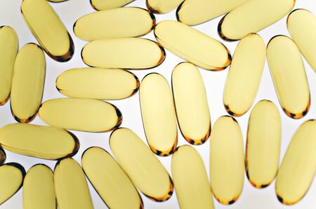 Close up of fish oil capsules on white backgroundの写真素材