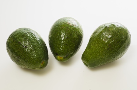 Three whole Avocado fruits on white backgroundの写真素材