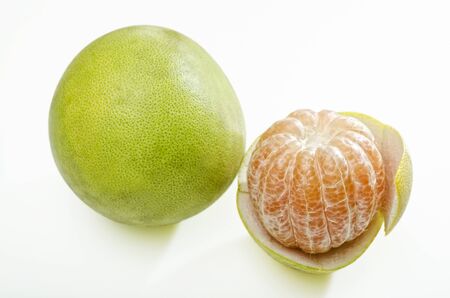 Two ripe pomelos shot on white backgroundの写真素材