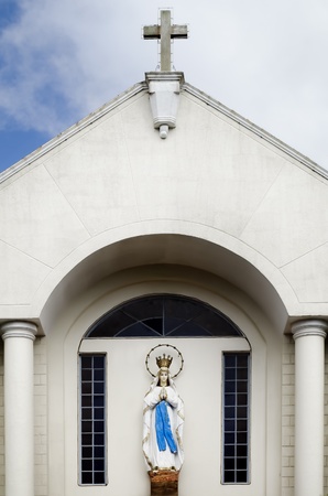 Statue of the Holy Virgin Mary on facade of a Catholic Churchの写真素材
