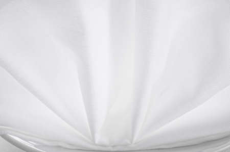 Close up of white table napkin on plateの写真素材
