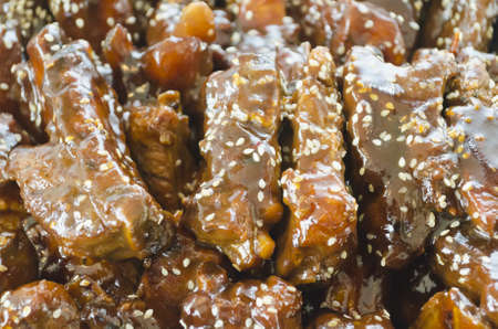 Spareribs cooked in oriental sauce and topped with sesame seeds
