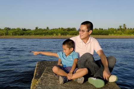 Father and son on a jetty during a bonding moment の写真素材