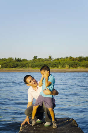 Father and son on a jetty during a bonding moment の写真素材