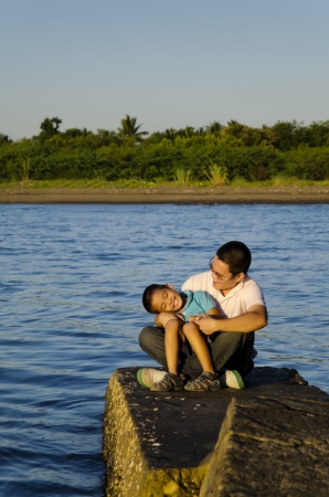 Father and son on a jetty during a bonding moment の写真素材