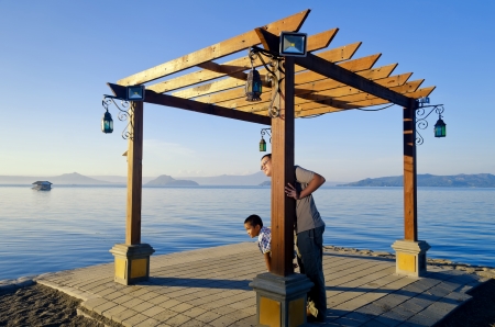 Father and son on a jetty during a bonding moment の写真素材