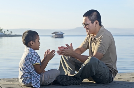Father and son on a jetty during a bonding moment の写真素材