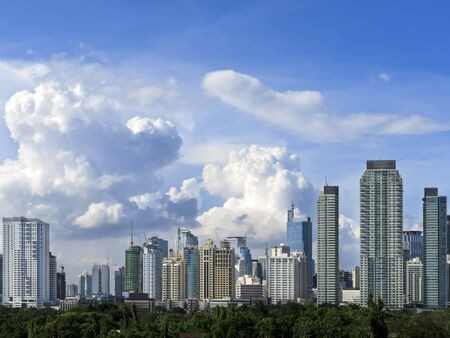 Makati skyline shot against blue sky and swirling cloudsの写真素材