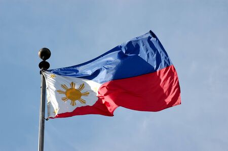 Full shot of wind blown flag of the Philippinesの写真素材