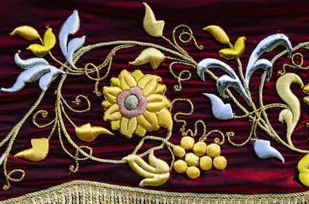 Embroidered flower on red suede clothの写真素材