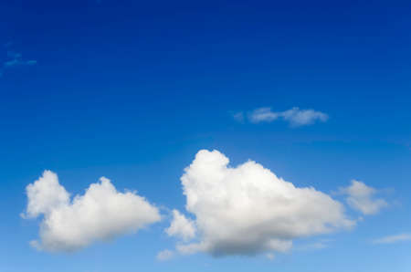 Fluffy cumulus clouds against blue skyの写真素材