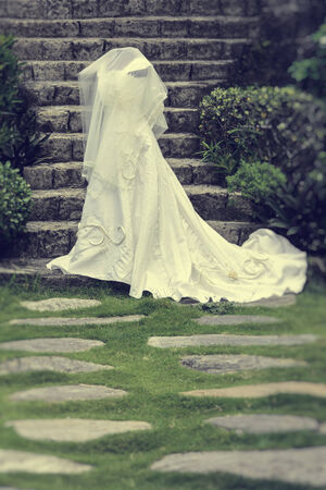White wedding gown shot in a gardenの写真素材