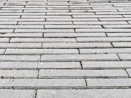 Rough, tiled floor outside a commercial buildingの写真素材