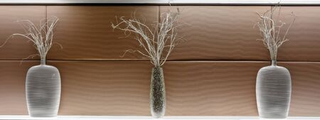Architectural vase decoration with painted twigs on wall