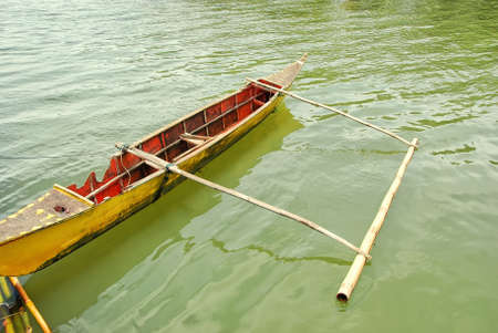 Dilapidated outrigger attached to a bamboo pierの写真素材