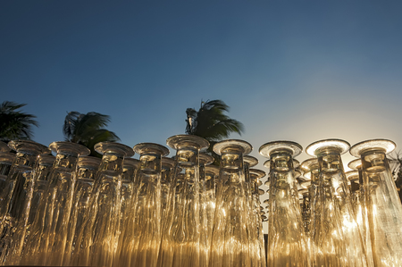 Stack of tall glasses in a summer garden settingの写真素材
