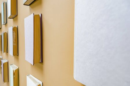 Real books stuck onto wall as a decorative designの写真素材