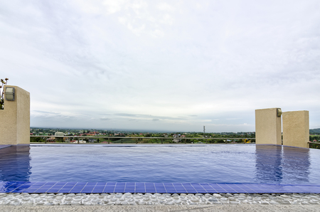 Small rooftop swimming pool with blue tilesの写真素材