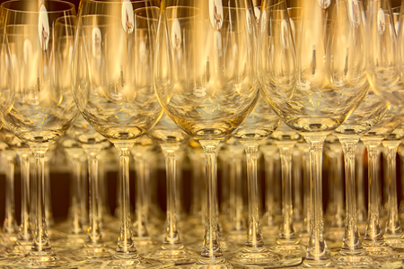 Rows and rows of empty water goblets in restaurantの写真素材