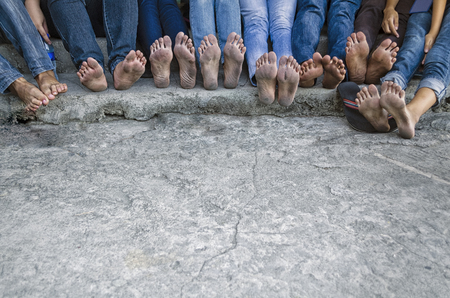 Line of barefeet of young people after a long processionの写真素材