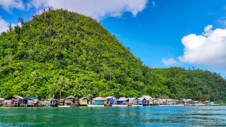 A picturesque scene of a majestic mountain towering beside a serene, azure sea where, a quaint...