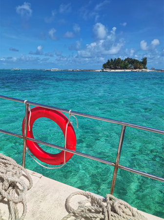 Red lifebuoy on a pier in the caribbean seaの写真素材