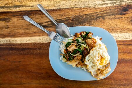 Rice and stir-fried crispy pork and basil with Fried egg background.の写真素材