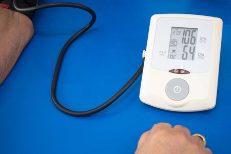 Digital Blood Pressure Monitor On a blue background