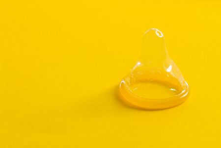 Condoms on yellow backgroundの写真素材
