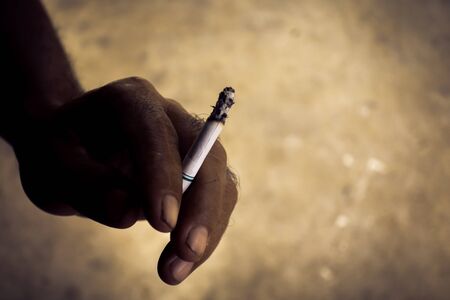 Cigarette in men's hands, close-up shot.の写真素材