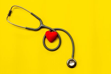 Stethoscope on a yellow background with space for text.の写真素材