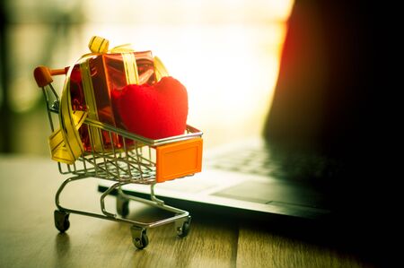 Online shopping concept - trolley cart full of presents.の写真素材