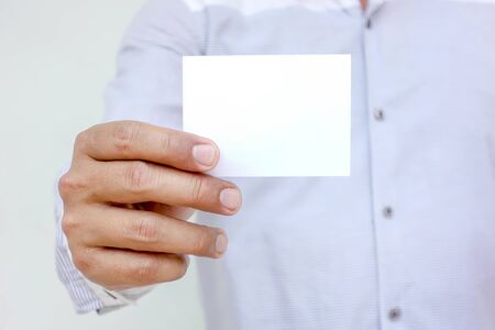 Human hand showing business cards - close-up image with white background.の写真素材