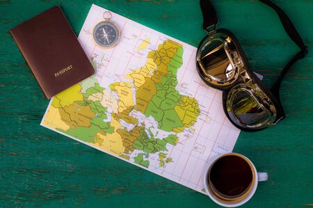 Travel, travel, travel, travel Turn off compass coffee mug Passport and glasses and a wooden trip map. Free space where you can place your message or information.の写真素材