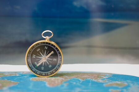 Magnetic compass on world map, concept of travel and destination, macro travel - Imageの写真素材