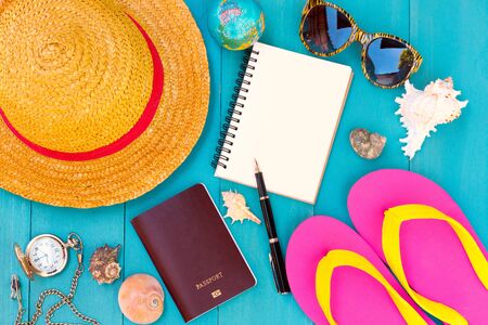 Conceptual tour planing image of travelling accessories on blue wooden backgroundの写真素材