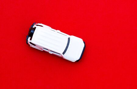White toy car on top view, red backgroundの写真素材