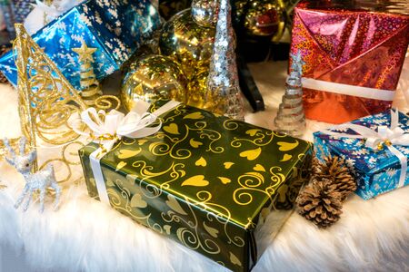 Beautiful Christmas gift boxes on floor near fir tree in roomの写真素材