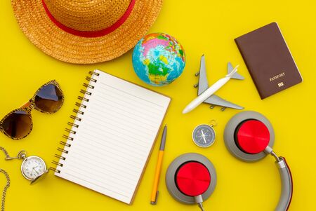 Summer Travel accessories and objects on Yellow background copy space, For Beach Vacation Journey with plane camera notebook, For Travel poster and banner advertisementの写真素材
