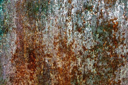 Rough and battered green paint texture on a rusted metal surface showing scratches, dents and rust...