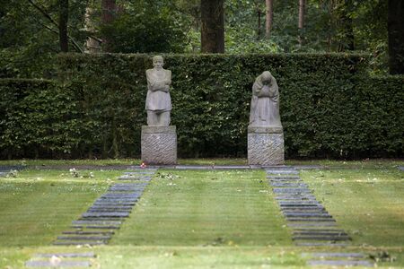 The German World War One war cemetery of Vladslo near Ploegsteert in Belgium and its statues of a grieving mother and fatherのeditorial素材