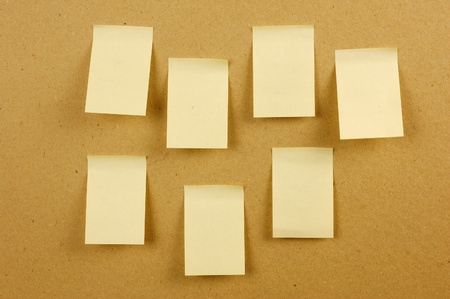 sheets of paper stuck to the wall brownの写真素材