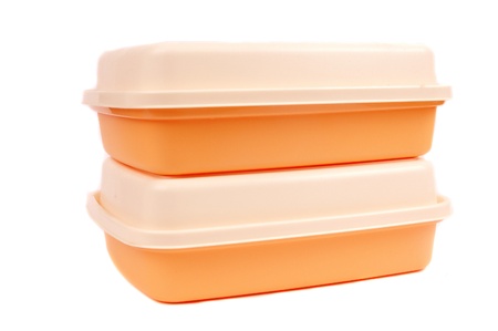 stack of orange storage plastic containers isolated on white backgroundの写真素材